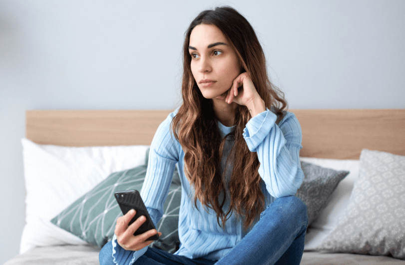 Girl sitting on couch contemplating