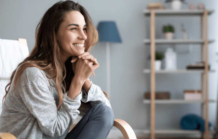 Girl smiling sitting on chair in modern apartment